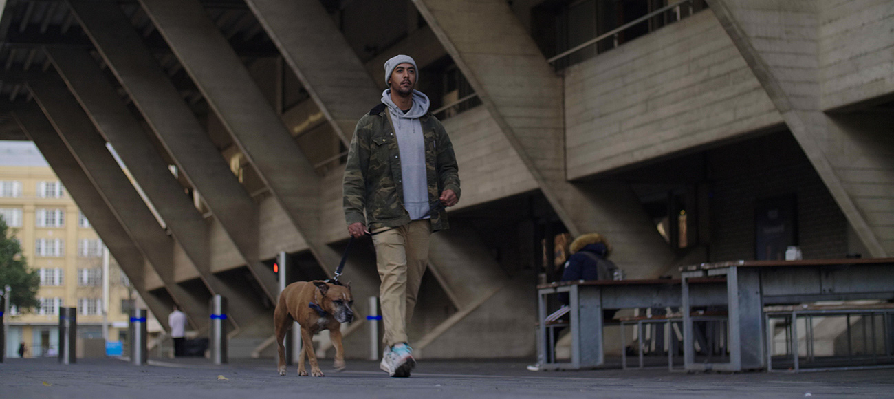 Nik out on a walk with Bruno, his dog.